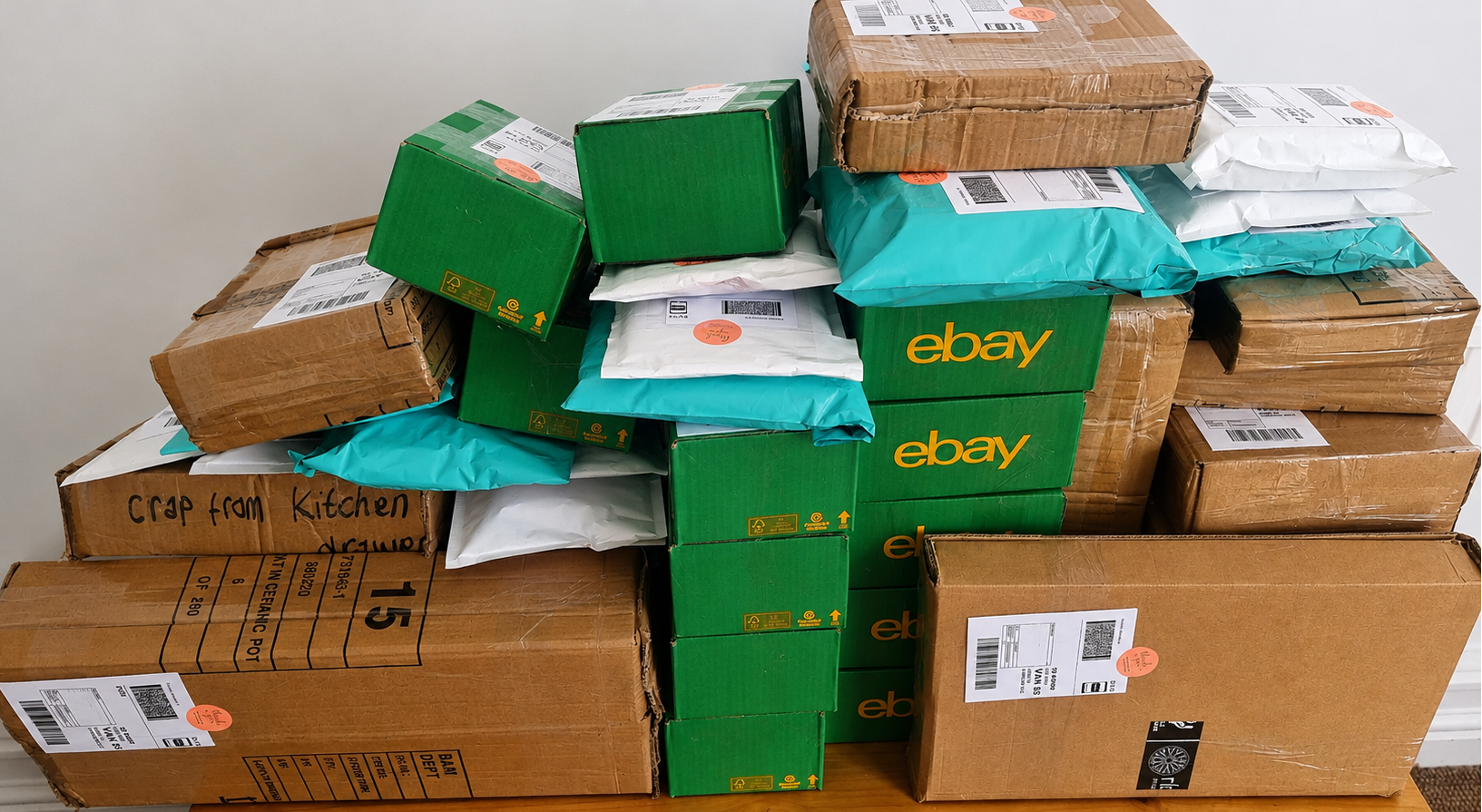 Stack of eBay packages on a wooden surface with a neutral background